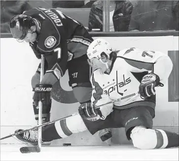  ?? Alex Gallardo Associated Press ?? THE OUTSTRETCH­ED leg of Capitals right winger T.J. Oshie makes it difficult for the Ducks’ Andrew Cogliano to get to the puck during the second period. Washington lost its fourth game in a row.