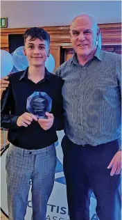  ?? ?? Recognitio­n Craig Johnson winning Scottish player of the year, with coach Michael Lavery, right