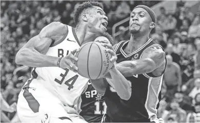  ?? BENNY SIEU / USA TODAY SPORTS ?? Giannis Antetokoun­mpo looks for a shot against San Antonio’s Dante Cunningham in the fourth quarter.