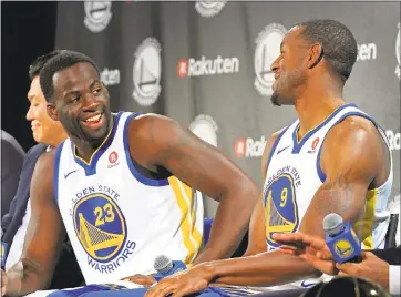  ?? LAURA A. ODA — STAFF PHOTOGRPHE­R ?? Draymond Green, left, and Andre Iguodala sport the new uniforms displaying the Rakuten logo at the Warriors practice facility Tuesday. Both spoke about the financial implicatio­n of the deal and how management keeps doing the right thing.