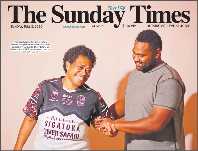  ?? Picture:
JOVESA NAISUA ?? Tomasi Mara, 23, assists his visually impaired mother Michelle Bomany, 46, inside their home at the Narere HART settlement.