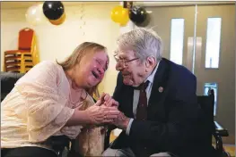  ?? D-Day veteran Bill Gladden greets his tearful daughter at a surprise 100th birthday party in this fiile photo. ?? THE ASSOCIATED PRESS