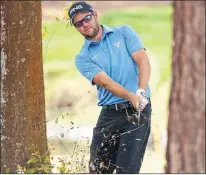  ?? AP PHOTO ?? Corey Conners hits out of the woods on the first hole during the final round of the Valspar Championsh­ip golf tournament Sunday in Palm Harbor, Fla.