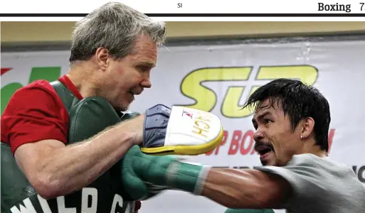  ?? AP ?? Southpaw stance: Pacquiao, who has only been using his left hand to punch in some sessions, hits Roach’s pads