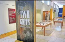  ?? THE OKLAHOMAN] [DOUG HOKE/ ?? The National Cowboy & Western Heritage Museum's exhibit “Two Grits — A Peek Behind the Eyepatch,” explores the two different films made from the 1968 novel “True Grit” by Charles Portis.