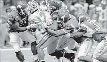  ?? Arkansas Democrat-Gazette/BENJAMIN KRAIN ?? Arkansas defenders swarm to bring down Ohio State punt returner Jordan Hall in the fourth quarter of the 2011 Sugar Bowl. The Hogs held the Buckeyes to three points in the second half, including none in the fourth quarter.