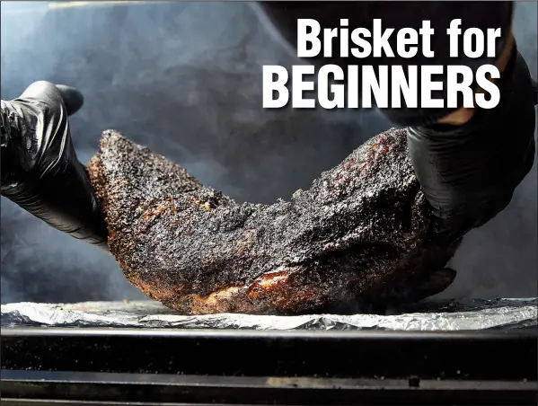  ?? The New York Times/TARA DONNE ?? Barbecued brisket goes under the bend test to check its doneness: lift the meat by the ends, if it sags in the middle, it’s done.