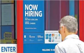  ?? ASSOCIATED PRESS FILE PHOTO ?? A "Now Hiring" sign welcomes a customer entering a Best Buy store in Hialeah, Fla. U.S. employers added a robust 222,000 jobs in June, the most in four months, a reassuring sign that businesses may be confident enough to keep hiring despite a...