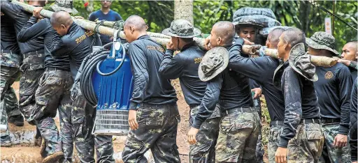  ?? LAUREN DECICCA/GETTY IMAGES ?? As drizzle starts to fall over the muddy rescue site, authoritie­s said they have a “limited amount of time” to get the boys out of the cave in Chiang Rai, Thailand.