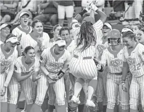  ?? OSU’s Morgyn Wynne (26) hits leaps toward home plate after hitting a home run late in a 3-1 loss to Tennessee on Sunday night in the Women’s College World Series at USA Softball Hall of Fame Stadium. NATHAN J. FISH/THE OKLAHOMAN ??