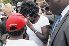  ?? STEVE RUARK/ THE ASSOCIATED PRESS ?? Gloria Darden, center, the mother of Freddie Gray, dabs tears Wednesday at a news conference held by Baltimore State’s Attorney Marilyn Mosby after prosecutor­s dropped remaining charges against three Baltimore police officers awaiting trial in Gray’s...