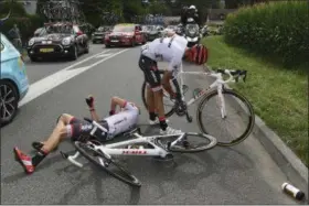  ?? FRANCK FAUGERE PHOTO VIA AP ?? Spain’s Alberto Contador, right, gets back on his bicycle after crashing with his teammate Austria’s Michael Gogl during the 11th stage of the Tour de France.