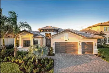  ?? PHOTOS PROVIDED ?? The stunning Charleston Grande design at Boca Bridges offers homebuyers four bedrooms, five baths, a club room/ optional fifth bedroom and a three-car garage.