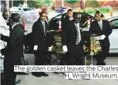  ??  ?? The golden casket leaves the Charles H. Wright Museum.