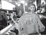  ?? AP/NASSER SHIYOUKHI ?? Palestinia­n-American Yasmeen Mjalli last month displays a jacket with the slogan “Not Your Habibti (Darling),” described as a retort for catcalls, in the West Bank city of Ramallah.