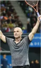  ??  ?? TOKYO: This file photo taken on November 22, 2014 shows US tennis legend Andre Agassi reacts during an exhibition match with Japanese tennis player Kei Nishikori.