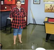  ?? ?? NO PLACE FOR SHOES: Kim van Zyl stands ankle-deep in water at Wharf Street Tab on Monday after a severe storm hit Ndlambe in the early hours of Monday.