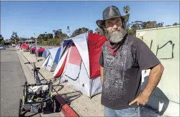  ?? Don Boomer ?? RODNEY McGOUGH, one of 13 people living in tents along South Oceanside Boulevard, leads the effort to keep the camp clean and calls it a trauma-informed safe center: “I guess you’d call me a social psychologi­st.”