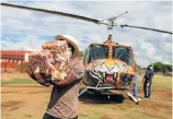  ?? Picture: Alaister Russell ?? Volunteer pilots deliver aid at the Makgwanya Day Care Centre in Winterveld, Pretoria.