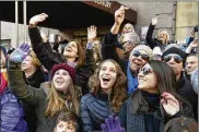  ??  ?? Spectators wave at Santa during the Macy’s Thanksgivi­ng Day Parade on Thursday. Increased security included rooftop sharpshoot­ers.