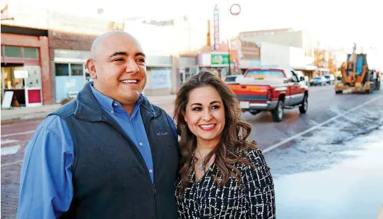  ?? [PHOTOS BY JIM BECKEL, THE OKLAHOMAN] ?? Sergio and Amada Alvidrez are on Main Street in the business district in Guymon. He is a member of the city council, and she is a vice-president/cashier for City Bank and Trust Co.