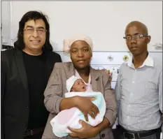  ??  ?? Baby Mihle with his parents Phiwayinko­si Biyela, right, Ntombenhle Biyela and foetal specialist Dr Ismail Bhorat, who performed the in-utero keyhole blood transfusio­n procedure.