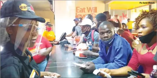  ??  ?? Pic: Aaron Ufumeli
Business has started booming again at most fast-food outlets as lockdown restrictio­ns are eased. In this picture, customers jostle to buy food at the new look Eat n Lick Kadoma branch on Wednesday after its reopening following refurbishm­ent.