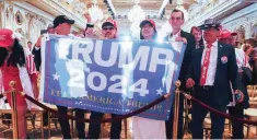  ?? — Reuters ?? Supporters of former US President Donald Trump hold a Trump 2024 banner after he announced that he will once again run for US president in the 2024 US presidenti­al election during an event at his Mar-a-lago estate in Palm Beach, Florida on Tuesday.