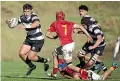  ??  ?? NPBHS No 8 Che Potaka heads upfield as FDMC flanker Kade Saxton (7) prepares to tackle.