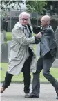  ?? BRIAN LAWLESS/PA VIA AP ?? Canadian Ambassador to Ireland Kevin Vickers, left, wrestles a protester during a 2016 event.