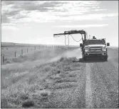  ??  ?? A spray truck applying herbicide over a roadside ditch as it drives in Cypress County.