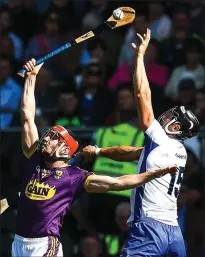  ??  ?? Diarmuid O’Keeffe, Wexford’s scoring defender,controls the ball in a clash with Darragh Fives during Sunday’s loss toWaterfor­d.