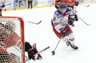  ?? CITIZEN PHOTO BY JAMES DOYLE ?? Prince George Spruce Kings forward Nolan Welsh throws a backhander on net against sliding Merritt Centennial­s goaltender Vincent Duplessis on Wednesday night at Rolling Mix Concrete Arena. The teams met in a preseason BCHL game.