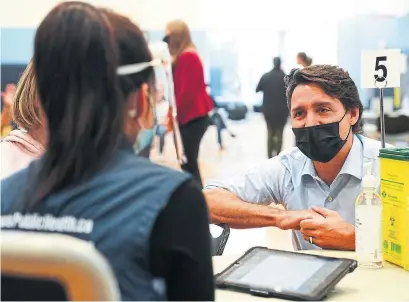  ?? SEAN KILPATRICK THE CANADIAN PRESS ?? Prime Minister Justin Trudeau visits a vaccine clinic in Ottawa on Tuesday. The ongoing COVID-19 crisis remains the government’s top priority, Trudeau said, acknowledg­ing in particular the trajectory of the pandemic’s fourth wave in Alberta and Saskatchew­an.