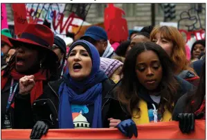  ?? AP/JOSE LUIS MAGANA ?? Linda Sarsour (center) and Tamika Mallory (right), two of the leaders of this year’s Women’s March, join the demonstrat­ors Saturday on Pennsylvan­ia Avenue in Washington.