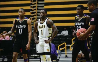  ?? (Pine Bluff Commercial/I.C. Murrell) ?? Jalen Lynn (1) of the University of Arkansas at Pine Bluff stands between DeWayne Cox (11) and Cam Mack (32) of Prairie View A&M during a Jan. 25 game in Pine Bluff. Prairie View won the game 73-56. The Golden Lions will face Prairie View A&M for the second time this season at 6 p.m. Tuesday in a game televised by ESPNU.