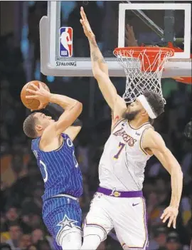  ?? Gary Coronado Los Angeles Times ?? JaVALE McGEE, guarding Orlando’s Aaron Gordon, became the third Laker since the 1999-2000 season to block seven shots in a game.