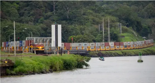  ?? David Lassen ?? As seen from a ship on the canal, a Panama Canal Railway container train heads toward the Caribbean port of Manzanillo in 2017.