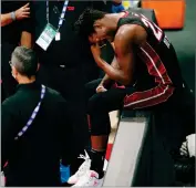  ?? AP PHOTO BY MARK J. TERRILL ?? Miami Heat’s Jimmy Butler (22) pauses after an apparent injury during the first half of Game 1 of basketball’s NBA Finals Wednesday, Sept. 30, in Lake Buena Vista, Fla.