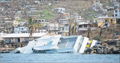  ?? [ERIKA P. RODRIGUEZ/THE NEW YORK TIMES FILE PHOTO] ?? A boat wrecked by Hurricane Irma rests against the shore in St. Thomas, U.S. Virgin Islands, shortly after the storm went through in September.