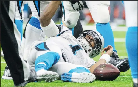  ?? AP ?? Panthers QB Cam Newton lies on the field after being sacked in the fourth quarter of their playoff loss to the Saints.