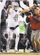  ?? Ezra Shaw / Getty Images ?? Quarterbac­k Derek Carr celebrates after the winning extra point.