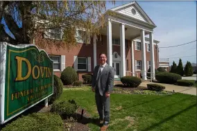  ?? THE MORNING JOURNAL FILE ?? Dovin Funeral and Cremation Specialist­s President John E. Dovin stands in the front lawn of his family’s business, which has served Lorain County since 1942.