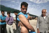  ?? — AP ?? Iranian farmer Mostafa Benvidi shows his wounds suffered during clashes between police and farmers in Varzaneh, Isfahan.