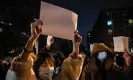  ?? Photograph: Kevin Frayer/Getty Images ?? Protesters hold up pieces of paper at a demonstrat­ion in Beijing on Sunday.