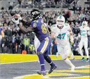  ?? Lloyd Fox Baltimore Sun ?? BENJAMIN WATSON’S two-yard touchdown catch gave the Ravens a 20-0 lead just before halftime.