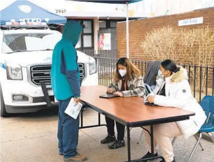  ?? BARRY WILLIAMS/FOR NEW YORK DAILY NEWS ?? A NYCHA resident registers to receive a COVID vaccine at the Polo Grounds Housing Project Senior Center in Manhattan. A staffer at the agency who sent anti-vax emails has been suspended indefinite­ly.