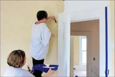  ?? TAWANA ROBERTS — THE NEWS-HERALD ?? Volunteers paint the Tikvah Recovery Home for Men, a recovery home in Willoughby that will provide alcohol-free and drug-free housing to men who are recovering from substance abuse.