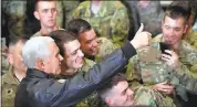  ?? MANDEL NGAN/ POOL VIA AP ?? U.S. Vice President Mike Pence poses for photos with troops at Bagram Air Base in Afghanista­n on Thursday.