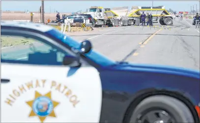  ?? Gregory Bull The Associated Press ?? California Highway Patrol officers investigat­e a deadly crash Tuesday in Holtville, Calif., near the U.s.-mexico border.